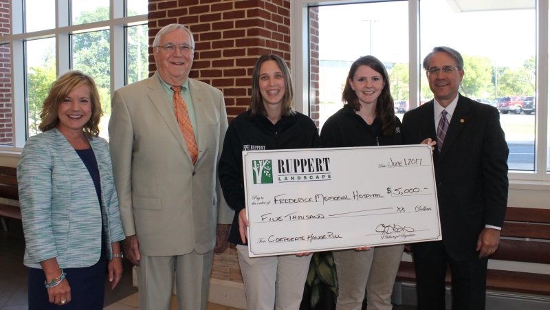 group holding large check